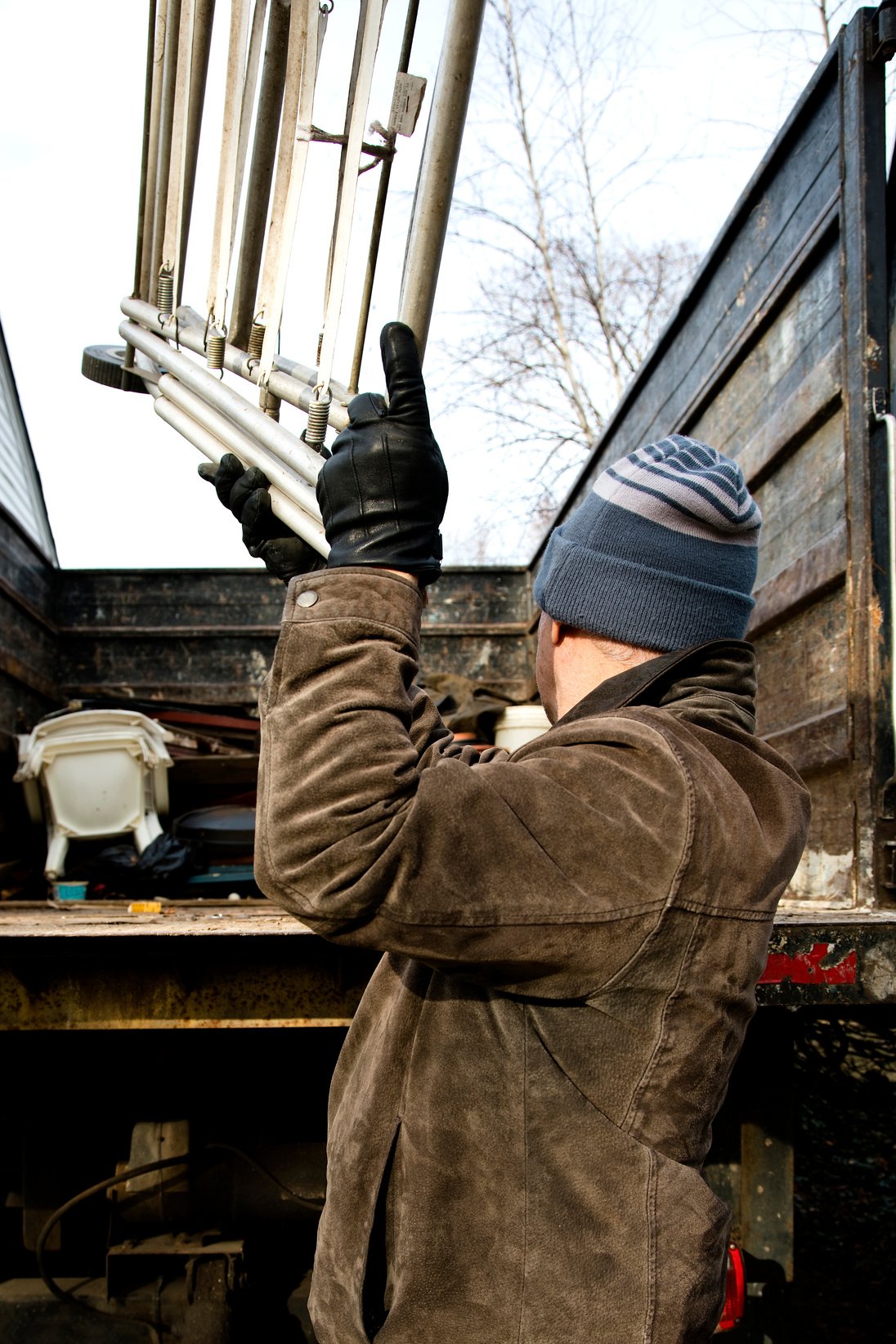 Man throwing  junk in back of truck